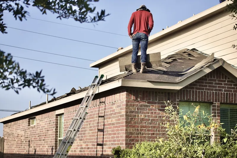 Professional roofer working on a residential roof in Clover Field